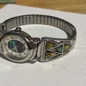 Cute colorful watch, silver stretchy band. Will need battery